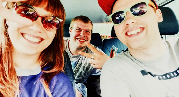 Three people in a car taking a selfie.